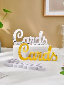 Detailed view of 3D 'Cards' decorative signs in gold, silver, and white finishes