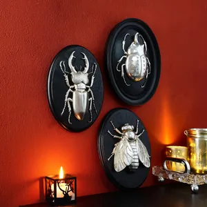 Set of three vintage insect resin wall reliefs in metallic silver finish on black plaques