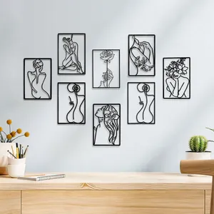 Set aus schwarzer Metallkunst, Frauen-Silhouetten und Blumen, an einer Wand im Heimbüro.