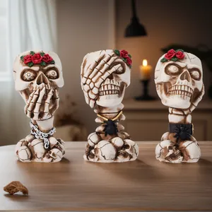 Detailed view of vintage skull makeup brush holders with red roses and spiders.