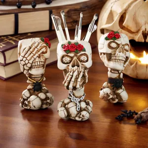 Vintage skull makeup brush holders with red rose details on wooden surface