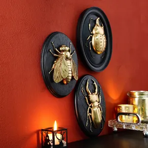 Vintage golden insect relief wall hanging set on black oval resin plaques