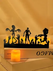 Detailed view of Halloween iron zombie silhouettes backlit by warm yellow LED candle glow