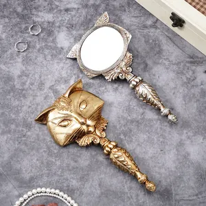 Vintage ornate gold and silver fox-shaped resin handheld mirrors for vanity decor.