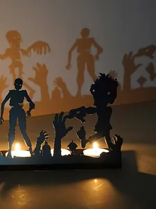 Iron zombie silhouettes Halloween candle holder casting spooky shadows on wall
