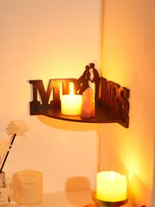 Wooden wedding corner shelf detail, MR & MRS wall decor with warm candle ambiance.