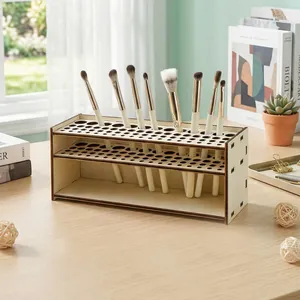 Detail of wooden makeup brush holder with multiple holes on a minimalist vanity desk