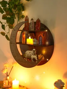 Close-up of decorative moon and sheep wooden shelf displayed with crystals and lights