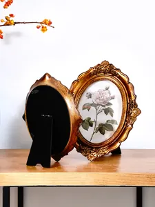 Detailed back and front view of a vintage bronze floral carved resin photo frame