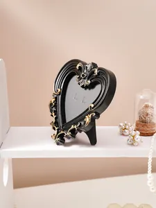 Detail of retro black and gold embossed heart photo frame with elegant French style relief