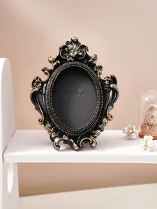 Vintage black and gold embossed photo frame with ornate French style desktop decor