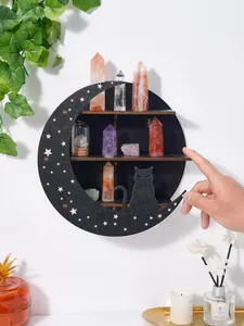 Detailed view of black moon-shaped wooden wall shelf with crystals and cat silhouette