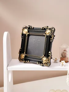 Detailed close-up view of a vintage black and gold embossed frame for elegant home decor.