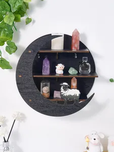 Close-up detail of a moon-shaped black wooden wall shelf featuring a creative sheep motif