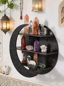 Detailed view of black crescent moon wall shelf holding crystals and small figurines