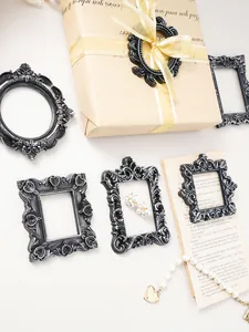 Variety of vintage European-style resin photo frames with ornate floral carvings in silver-black