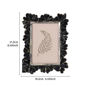 Vintage black and gold floral photo frame detail showing 21.5cm height and 16.5cm width