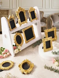 Detailed view of ornate gold vintage relief photo frames for desktop decoration
