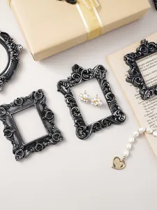 Macro detail view of vintage embossed resin photo frames used as photography props