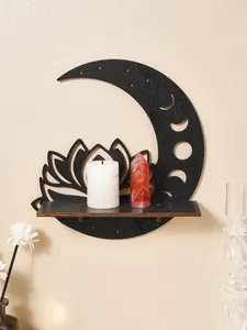 Detail of a black wooden moon and lotus wall shelf with a candle and crystal point.