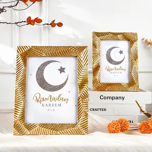 Set aus zwei eleganten goldgestreiften geschnitzten Fotorahmen für die Tischdekoration