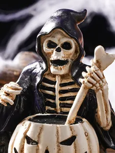 Macro detail of skeleton wizard figurine stirring a pumpkin cauldron for Halloween decor