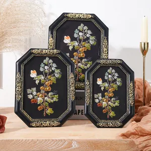Set of three vintage octagonal botanical picture frames with floral resin relief carvings.