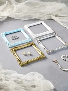 Detailed macro shot of European palace style embossed square frames for jewelry display.