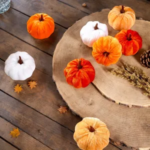 Detailed view of soft velvet artificial pumpkins in white and orange for autumn decor