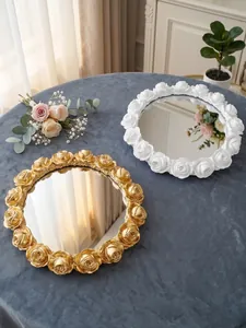 Macro view of vintage resin rose relief decorative mirror trays in gold and white finish