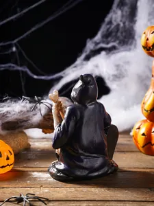 Back view of a detailed resin wizard figurine in a spooky Halloween setting