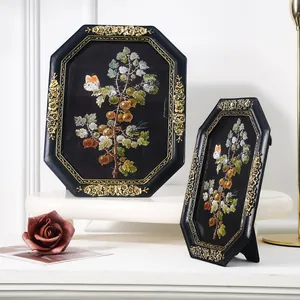 Close-up of vintage octagonal resin photo frames with ornate gold floral carving details.