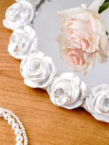 Detailed macro view of vintage white resin tray with embossed rose carving design