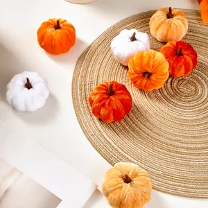 Assorted soft velvet plush pumpkins in white and orange for autumn DIY festive home decor.
