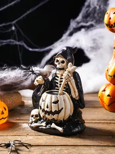 Close-up of resin skeleton wizard ornament stirring a pumpkin cauldron for Halloween