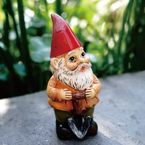 Detailed view of hand-painted garden gnome holding a shovel for outdoor decor
