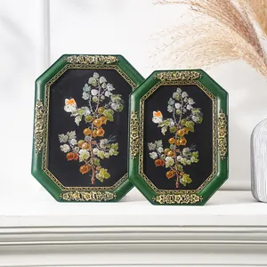 Detailed view of vintage octagonal resin frames with botanical art illustrations