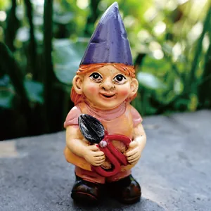 Detailed view of a miniature garden gnome holding red garden shears for outdoor decor.