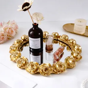 Detailed view of a vintage gold rose embossed resin round decorative mirror tray.
