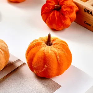 Close-up of a soft orange velvet artificial pumpkin for autumn home DIY decoration