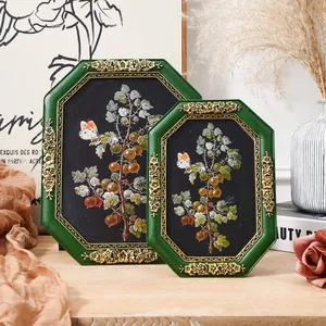 Macro view of intricate gold floral patterns on vintage green octagonal resin frames