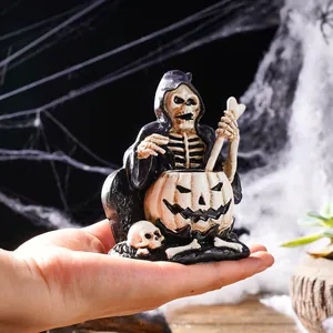 Mini Halloween reaper skeleton resin figurine sitting in a carved jack-o'-lantern