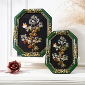 Detailed view of vintage octagonal green resin frames with gold floral embossing decor