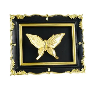 Elegant vintage black and gold photo frame featuring a 3D gold butterfly wall decoration