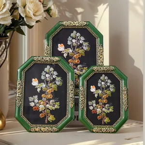 Set of three vintage octagonal resin photo frames with green and gold floral details