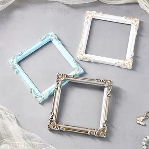 Vintage European style embossed square jewelry display frames in blue, white, and silver