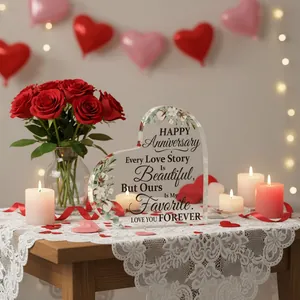 Detail of a heart-shaped acrylic anniversary plaque with elegant floral patterns