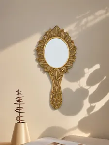 Detailed view of the intricate golden leaf pattern on a vintage French resin mirror