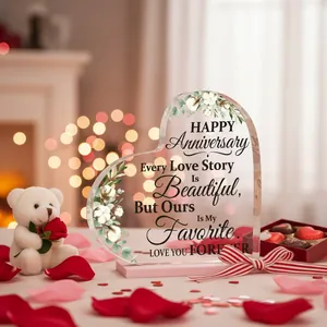 Detailed view of a heart-shaped acrylic anniversary plaque with elegant floral motifs