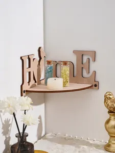 Close-up of a wooden HOME themed corner shelf styled with decorative glass bottles and candle